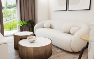 Nowoczesny projekt wnętrza salonu w jasnej kolorystyce z obłą sofą, drewnianymi stolikami kawowymi i minimalistycznymi grafikami na ścianie