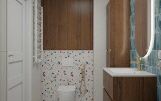 Mała łazienka z kolorowymi płytkami terrazzo, turkusowo-niebieską ścianą, drewnianą zabudową, złotą armaturą i podświetlanym lustrem.